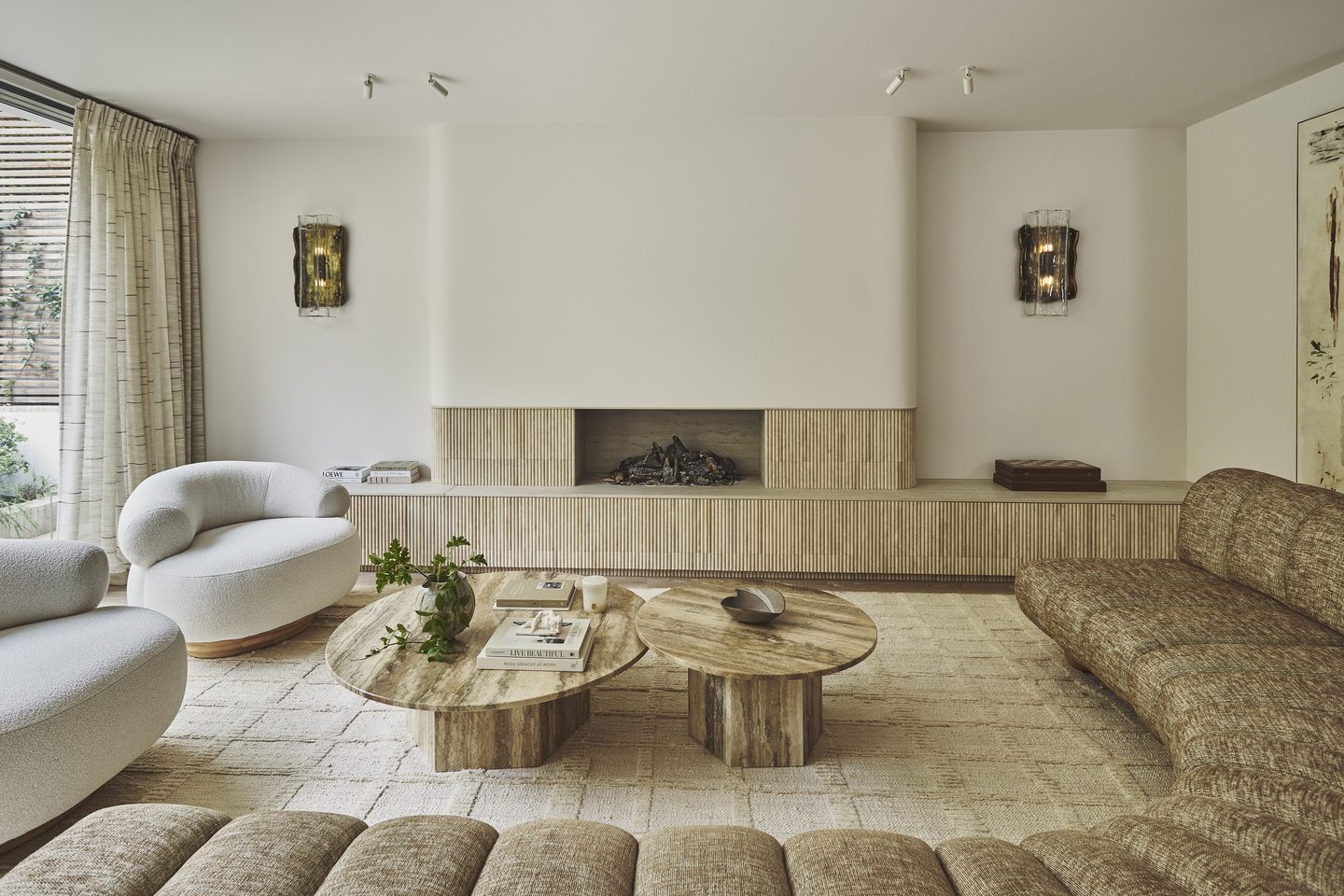 Reception room with fluted stone fireplace and built-in banquette seating