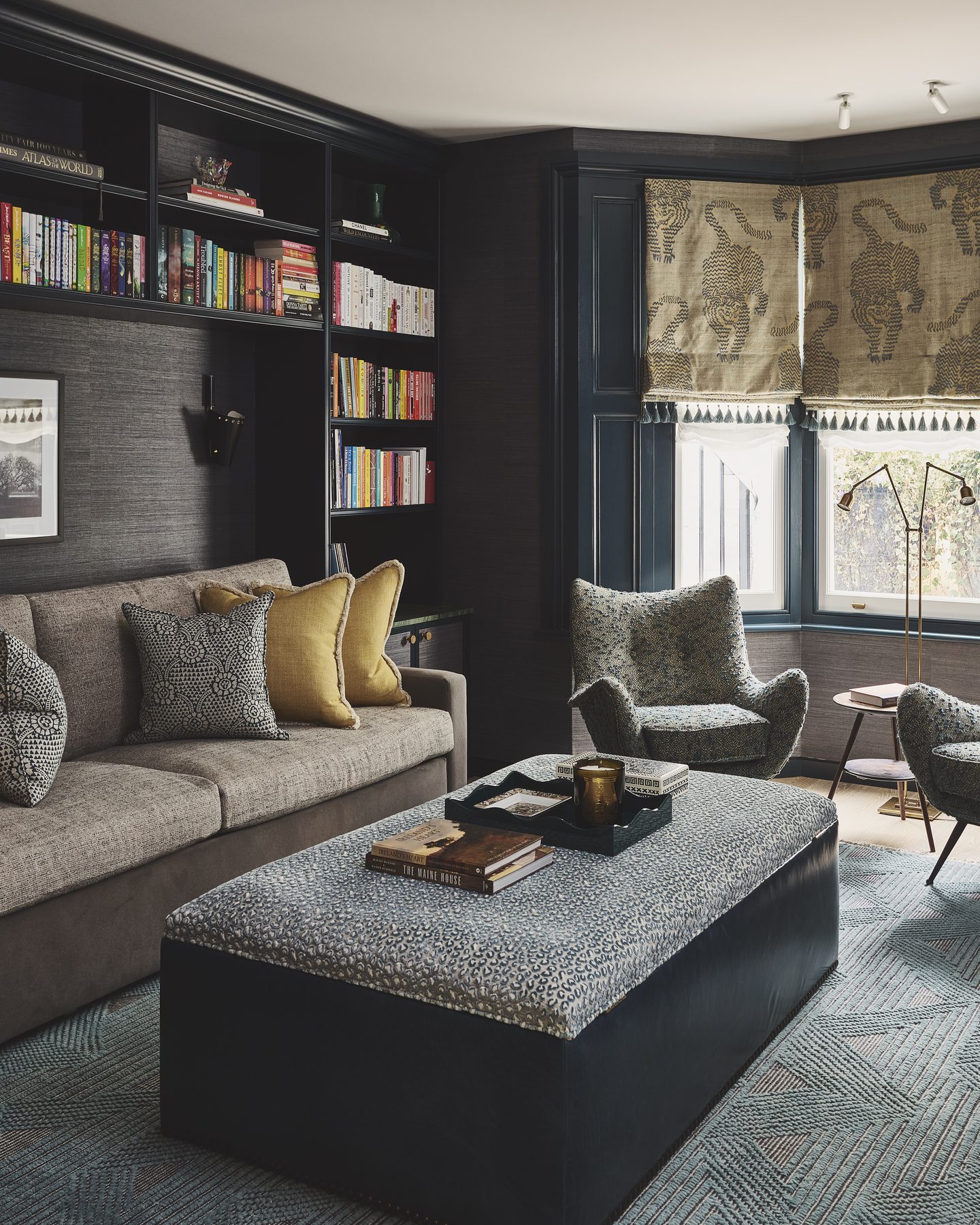 Panelled snug with fitted bookshelves and deep upholstered seating
