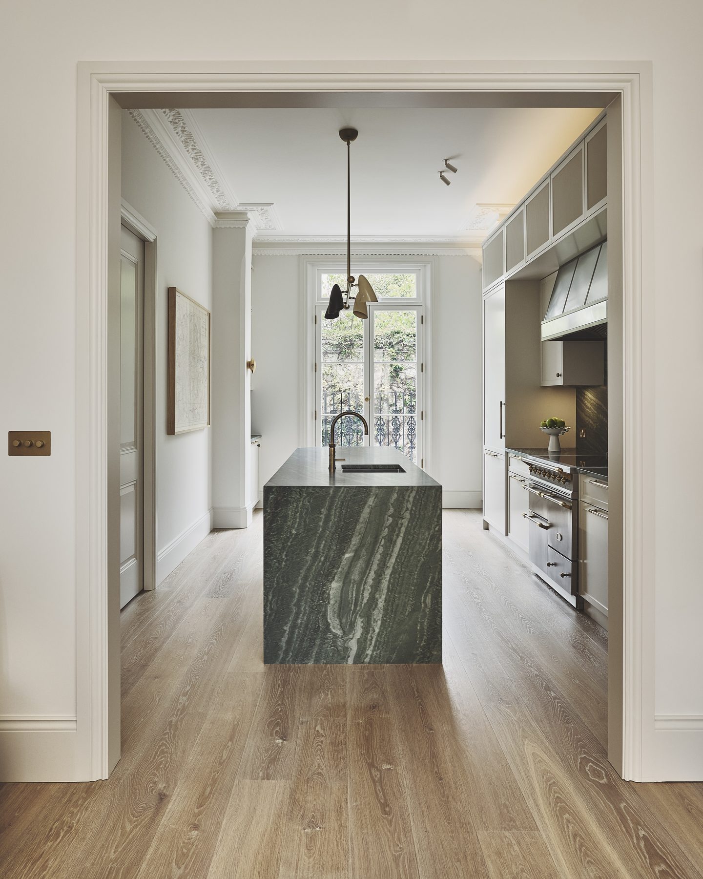 Hallway looking through to the kitchen and its green marble island