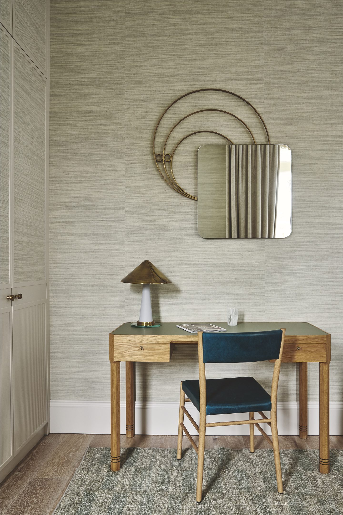 Dressing area with slim writing desk and wall mirror