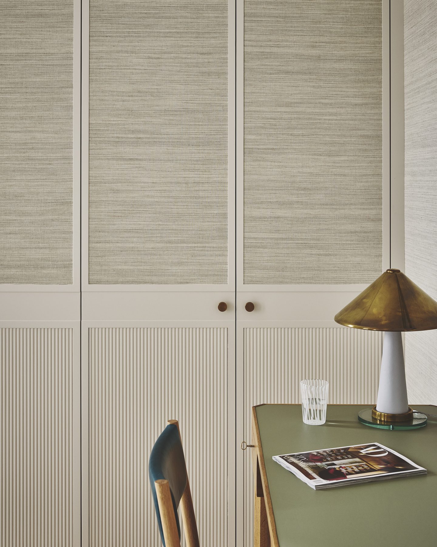 Bedroom detail with fluted wardrobe doors and green lacquered desk