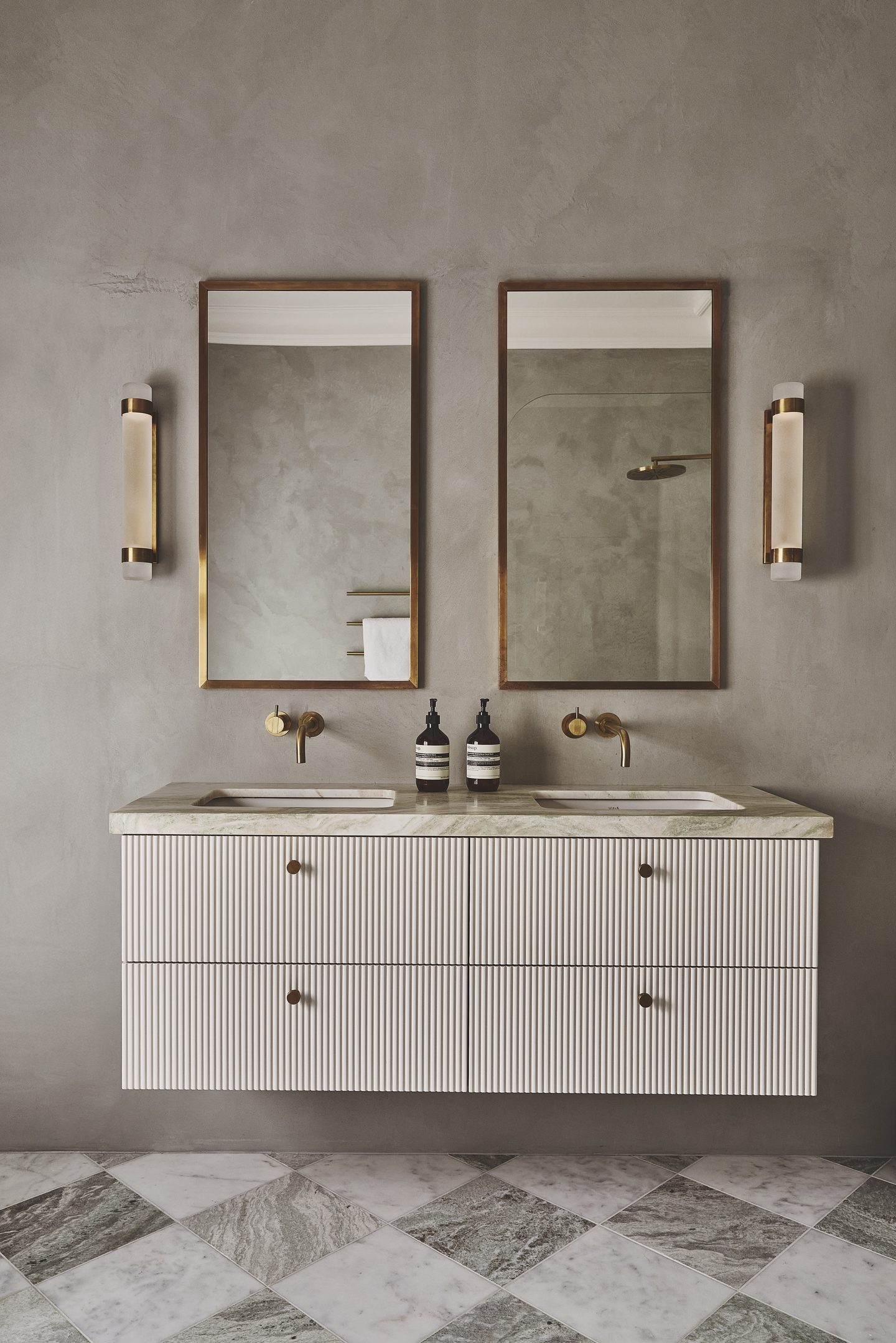 Bathroom with twin vanities, brass fittings and microcement walls