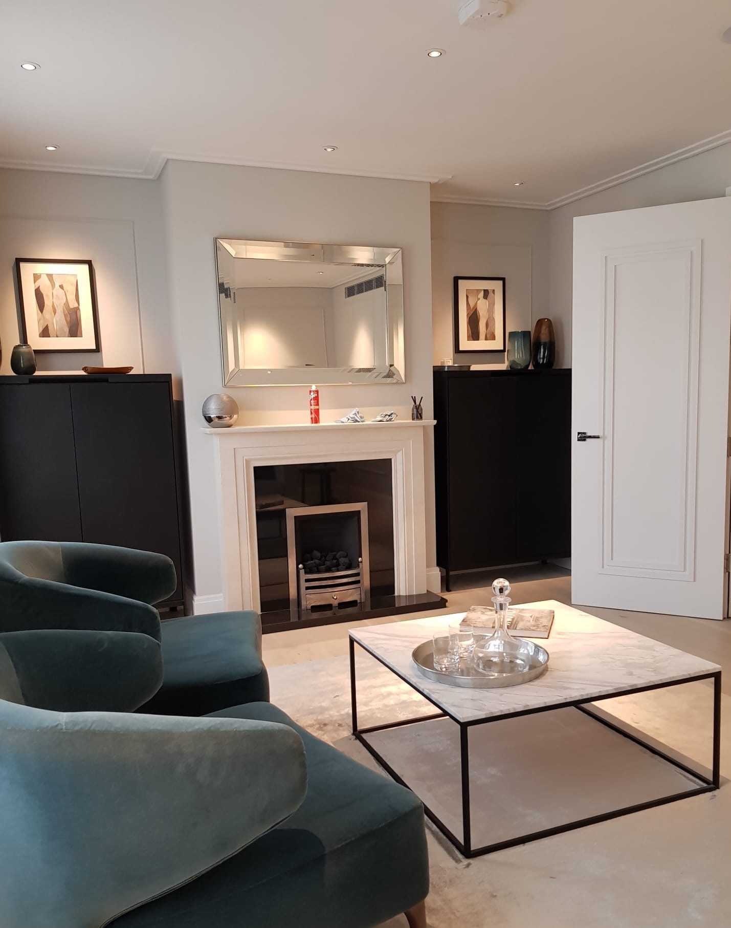 Sitting room with fireplace and armchairs