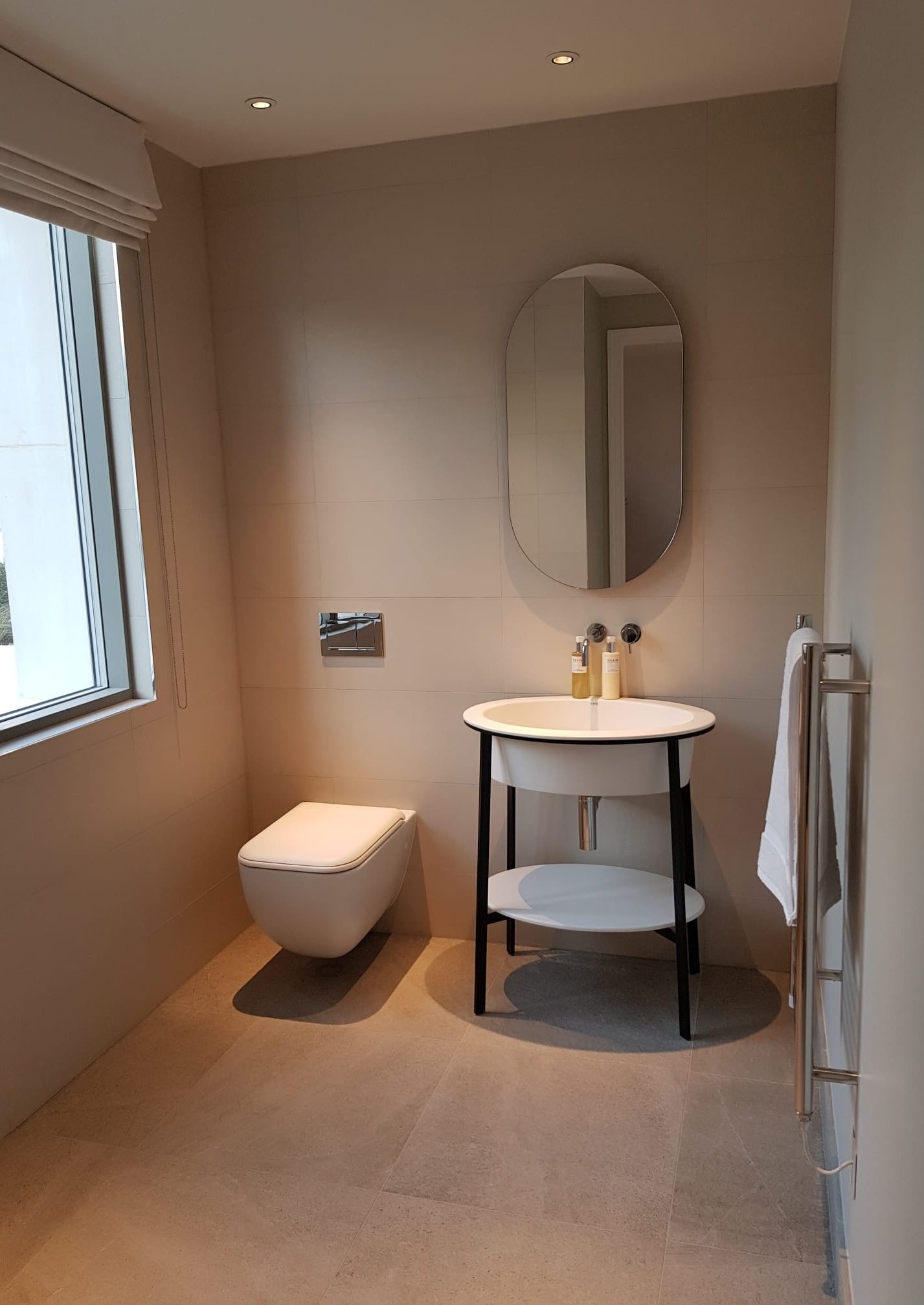 Cloakroom with oval mirror