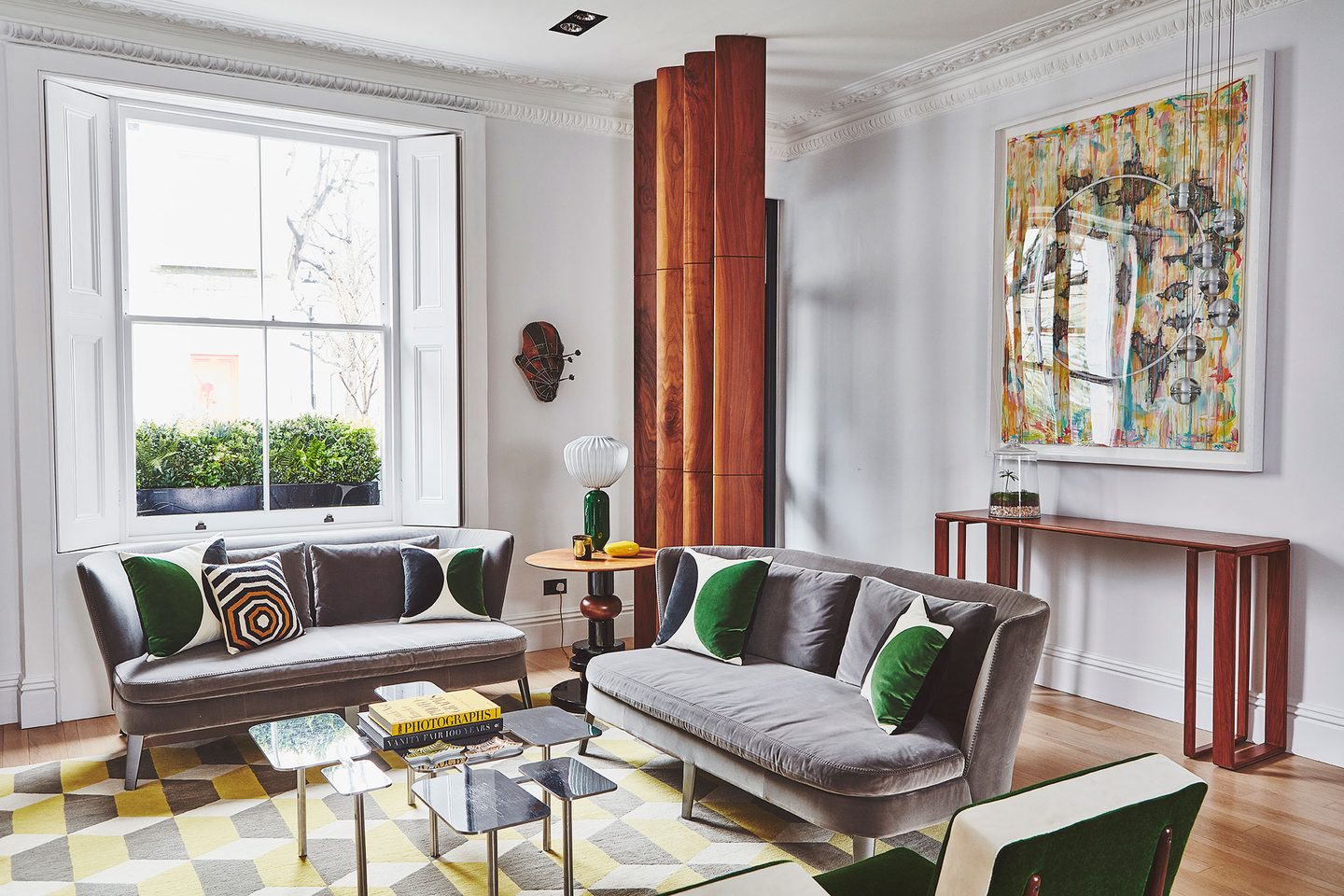 Drawing room with velvet seating and geometric rug