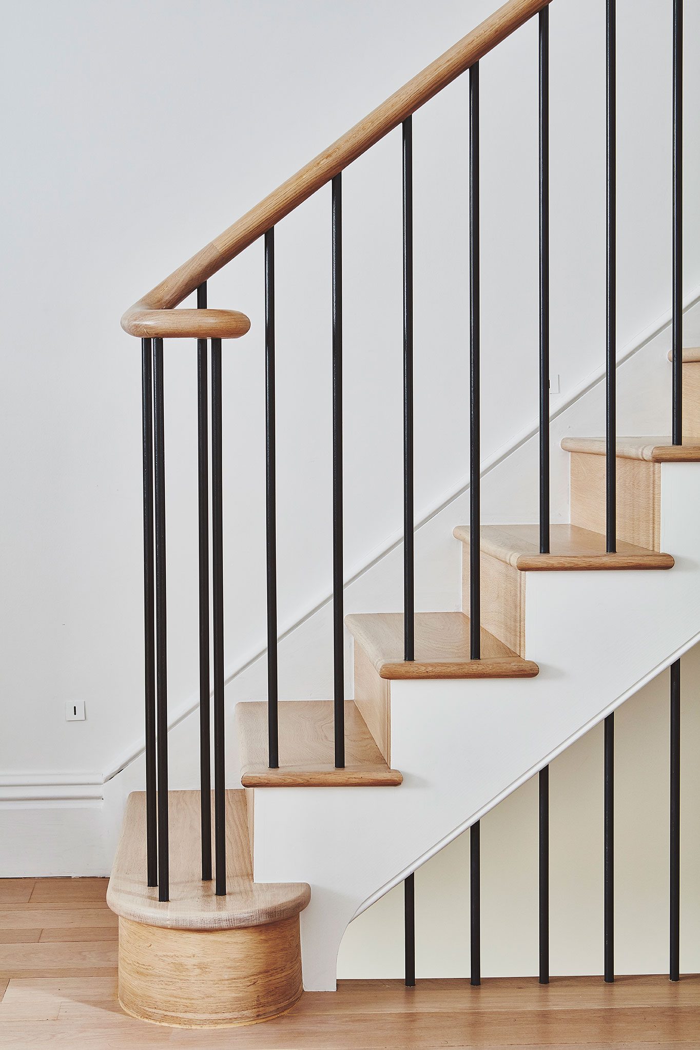 Staircase detail with bespoke oak handrail and bullnose step