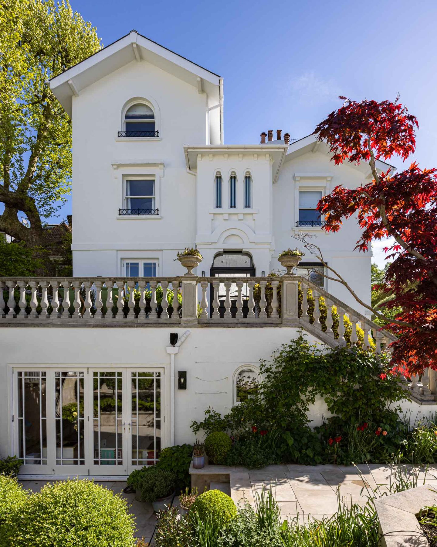 Rear elevation with balustraded terrace and mature planting