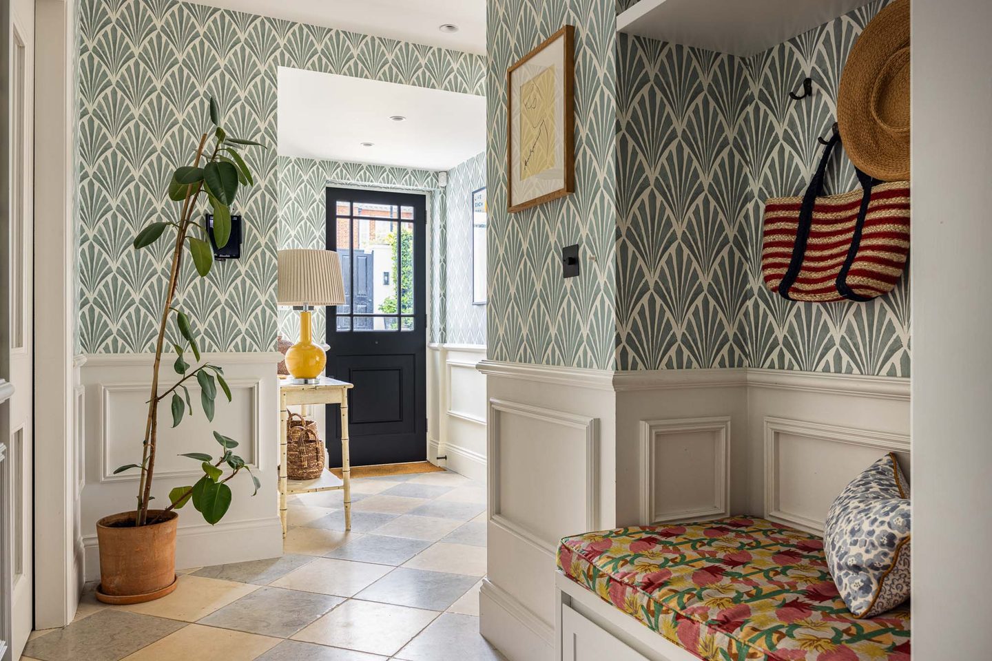 Boot room with patterned wallpaper and built-in bench seating