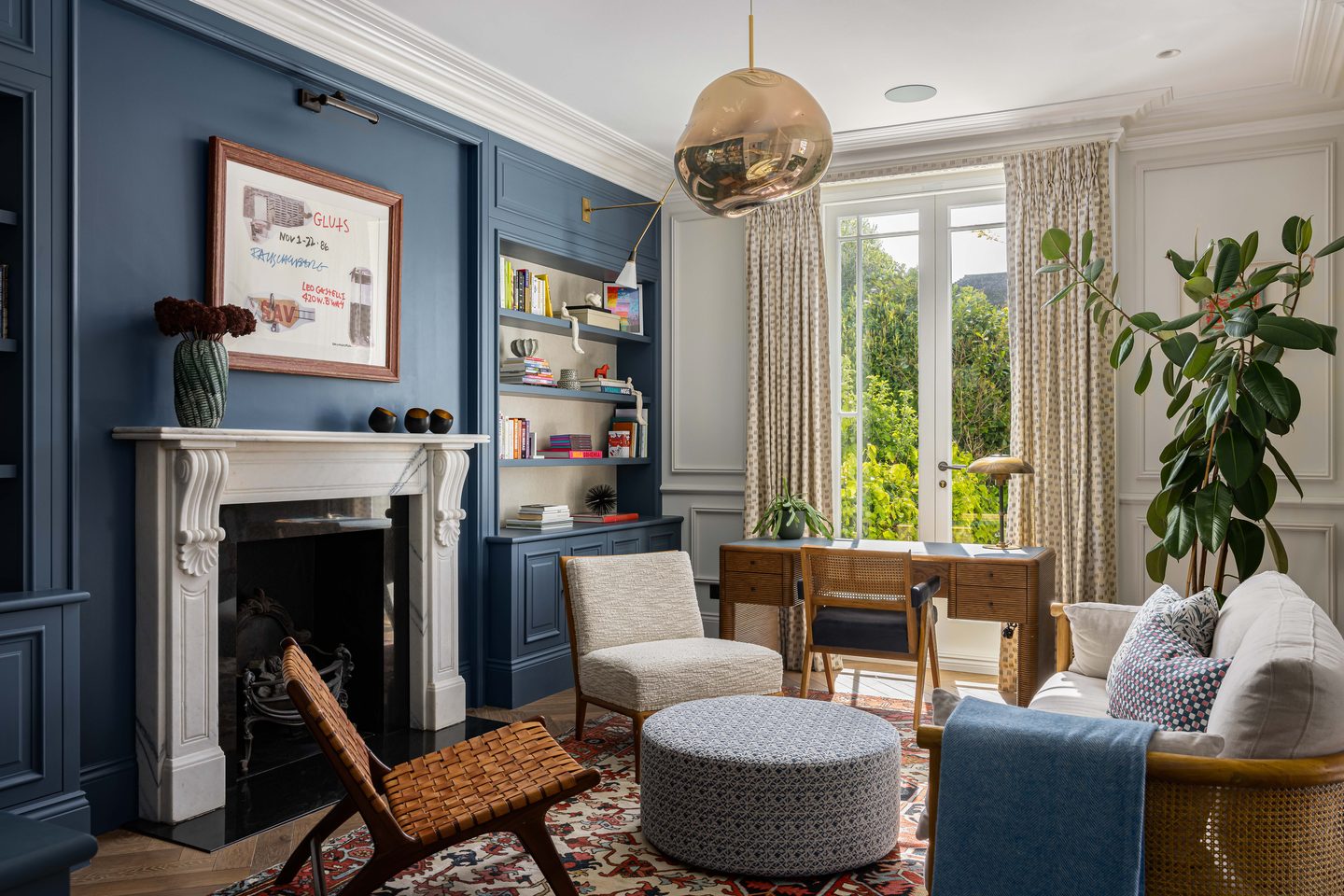 Sitting room in deep blue with alcove shelving and open fire