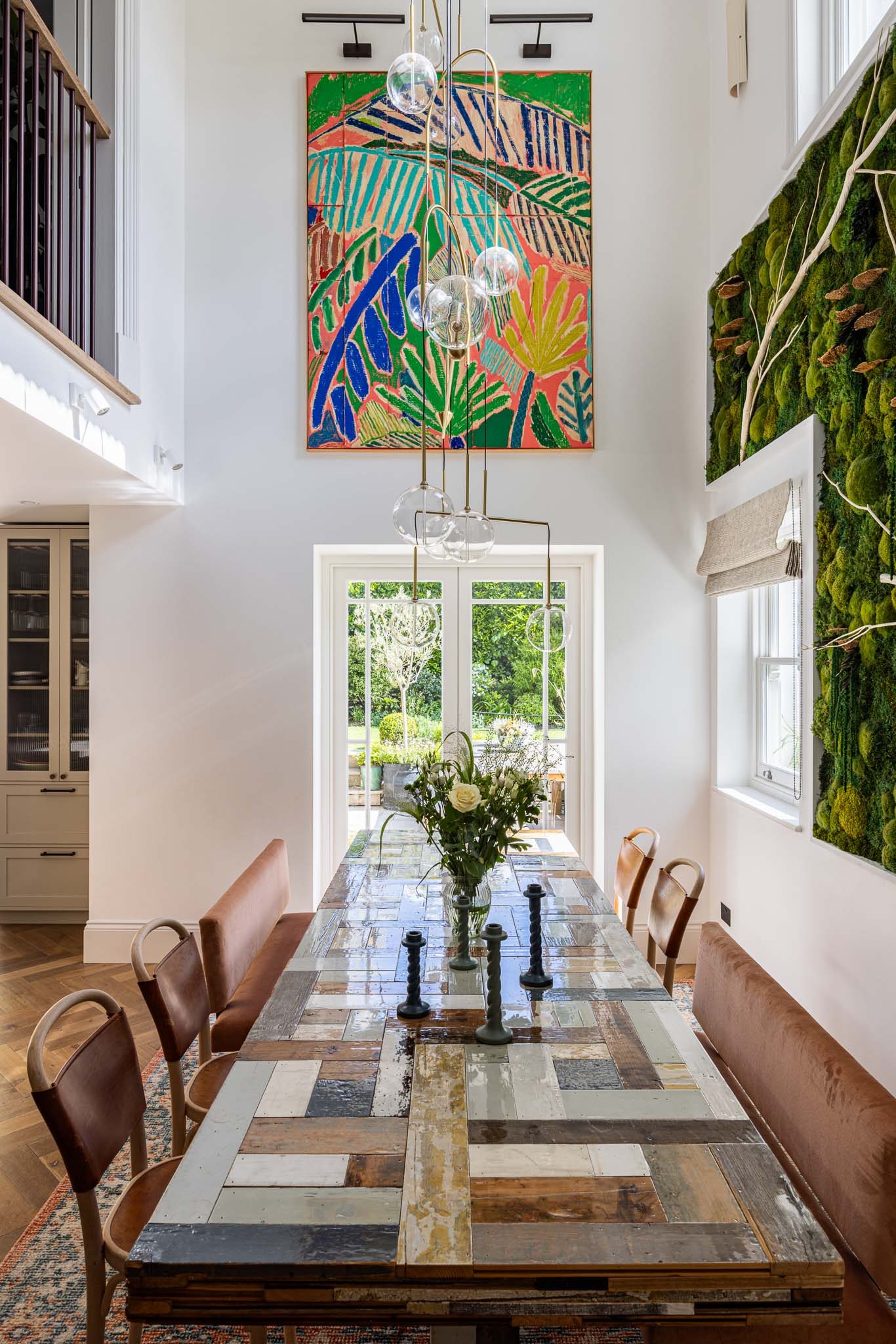 Dining room with long table and garden outlook