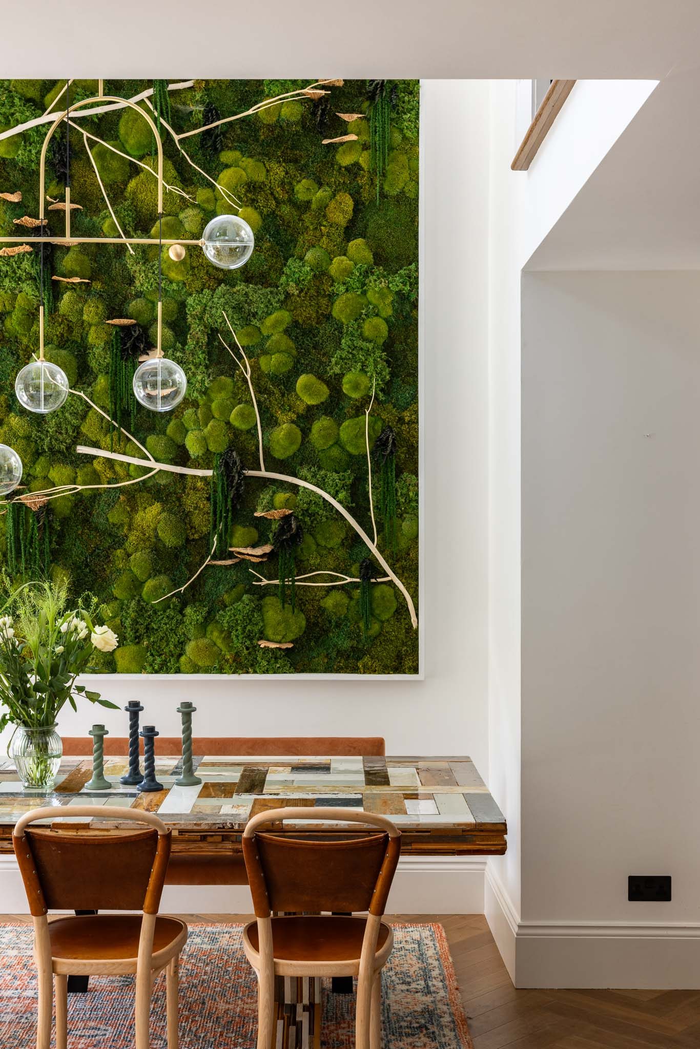 Dining area beside a planted living wall