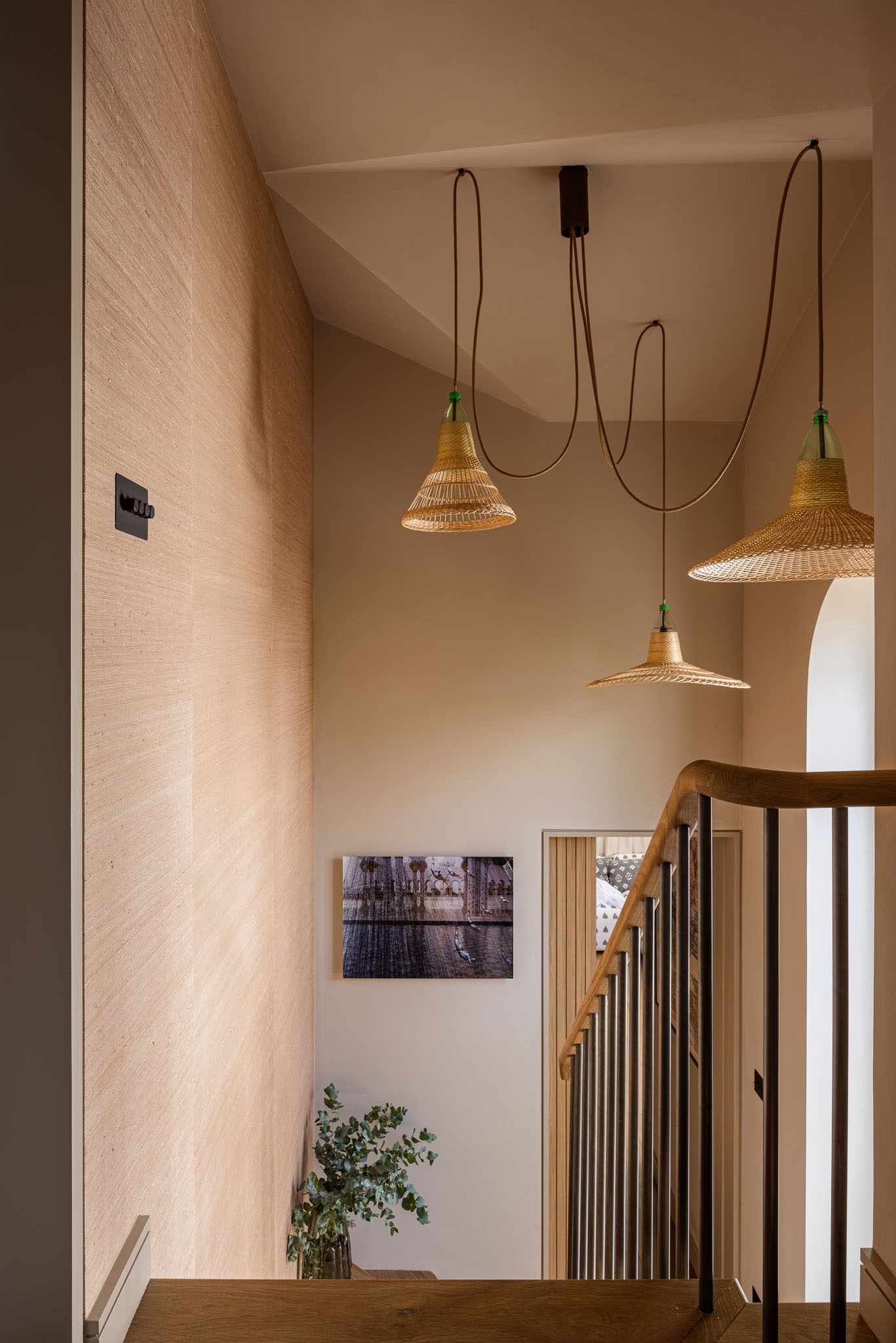 Top-floor landing lined in timber with cluster pendants