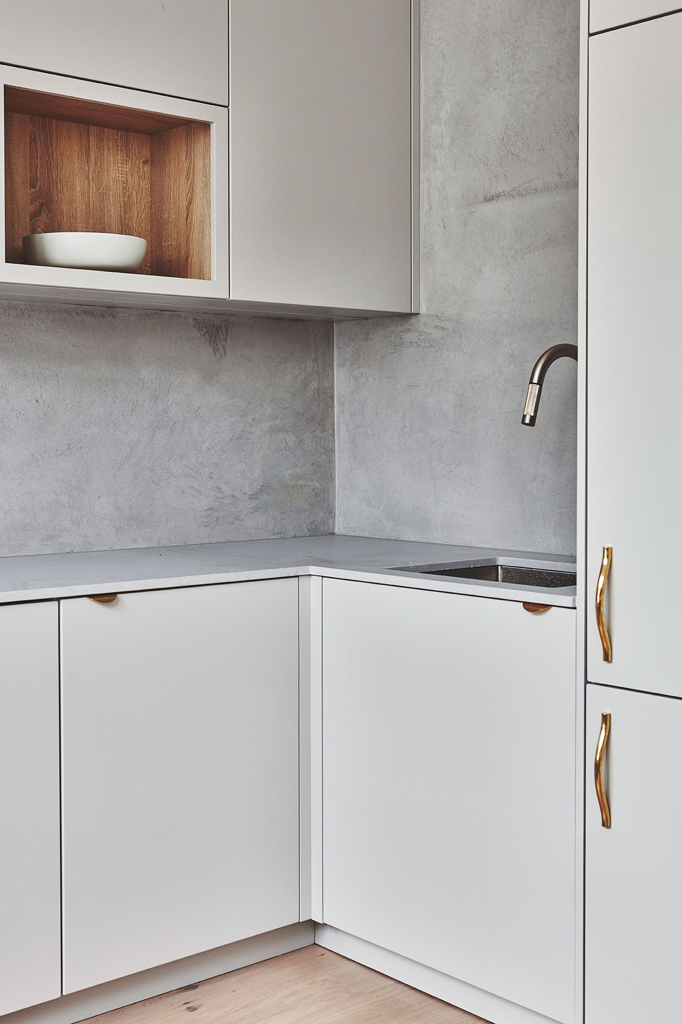 Kitchen corner with brass tap and open shelf