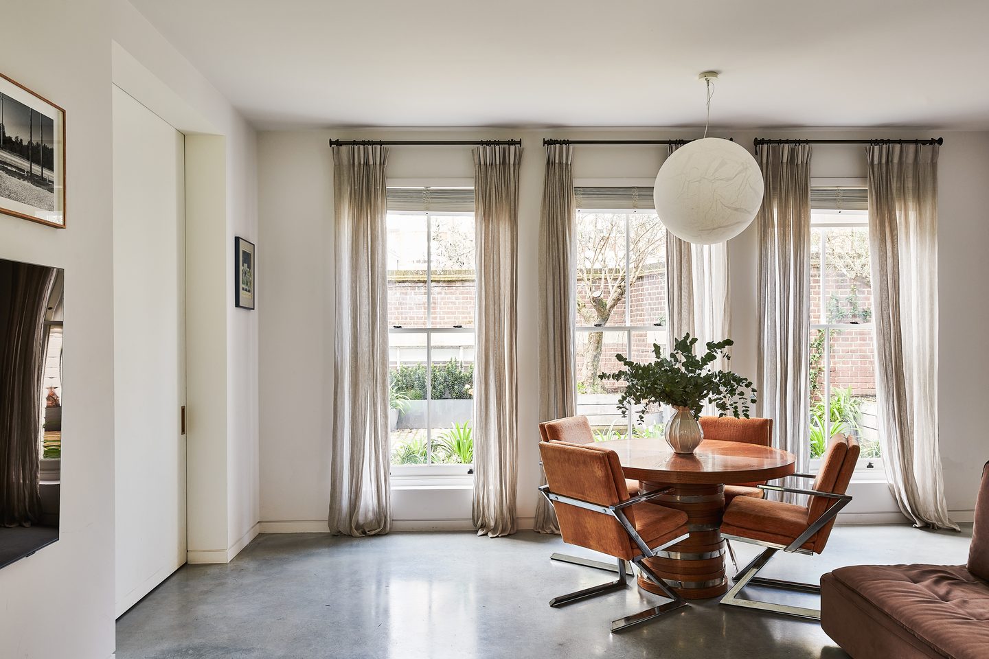 Dining area with round table and globe pendant