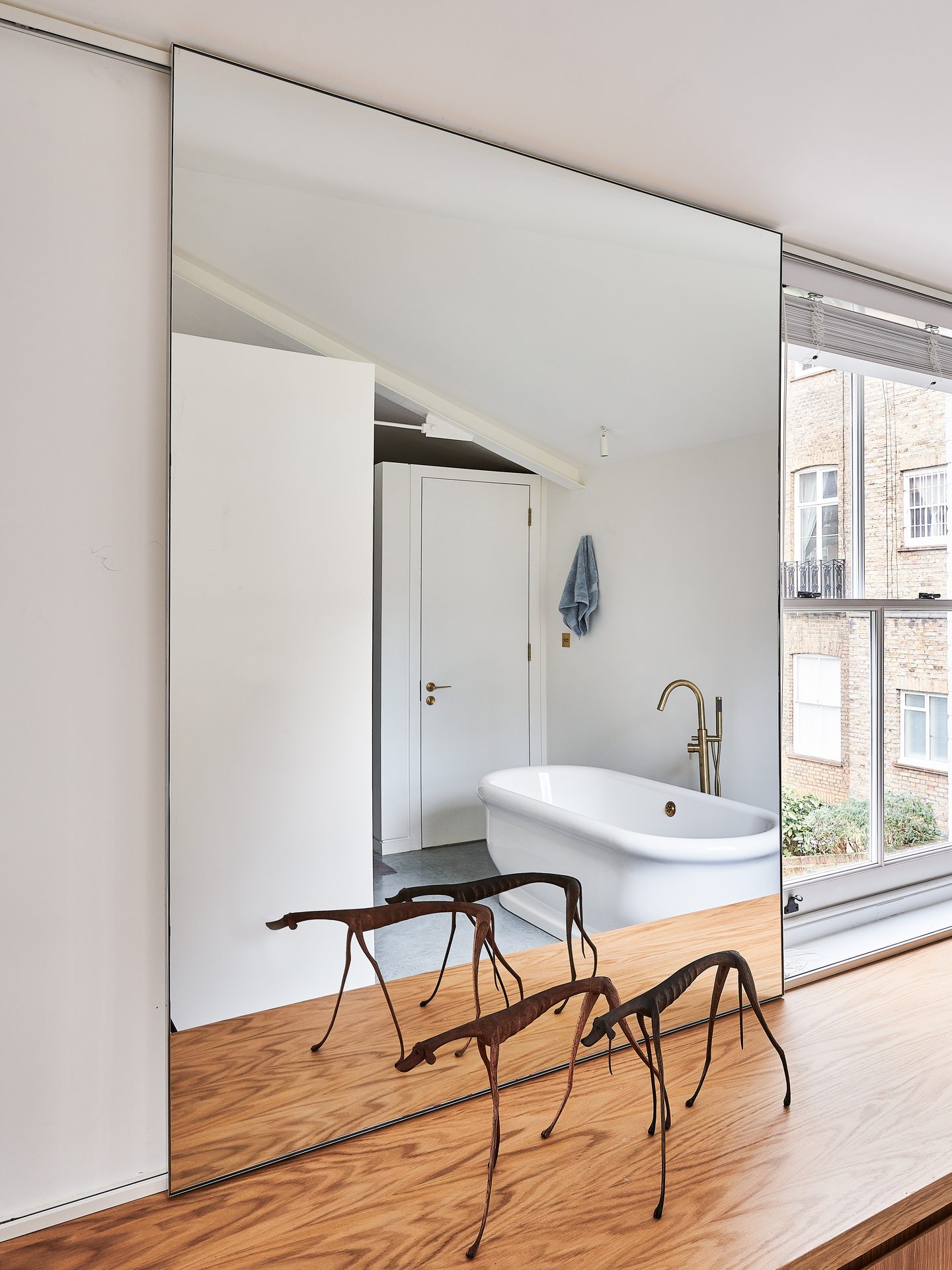 Bathroom with freestanding bath and sliding mirrored door