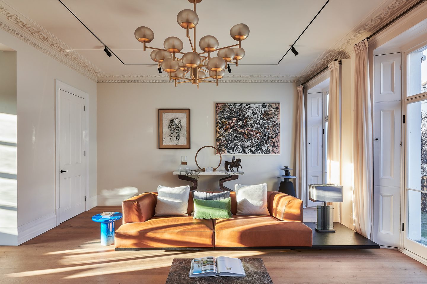 Drawing room with tall windows and brass chandelier