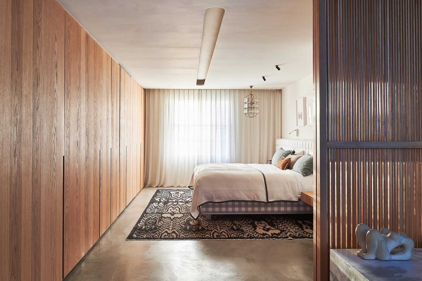 Bedroom with full-height oak joinery and slatted screen