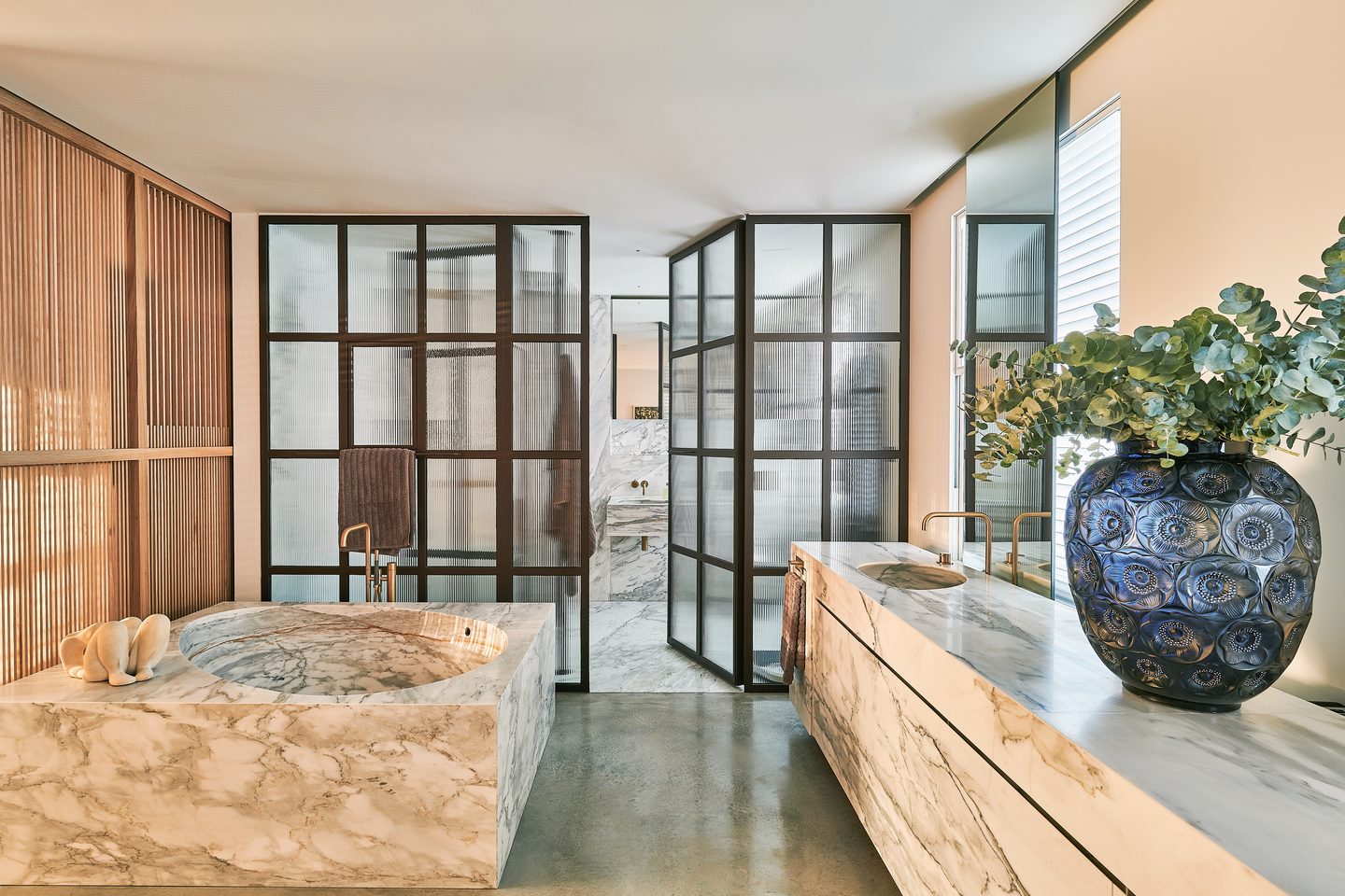 Bathroom with marble bath and steel-framed screens
