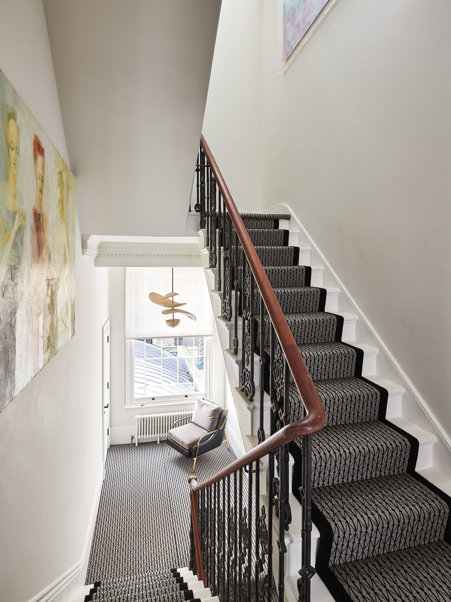Staircase with stair runner and black balustrade