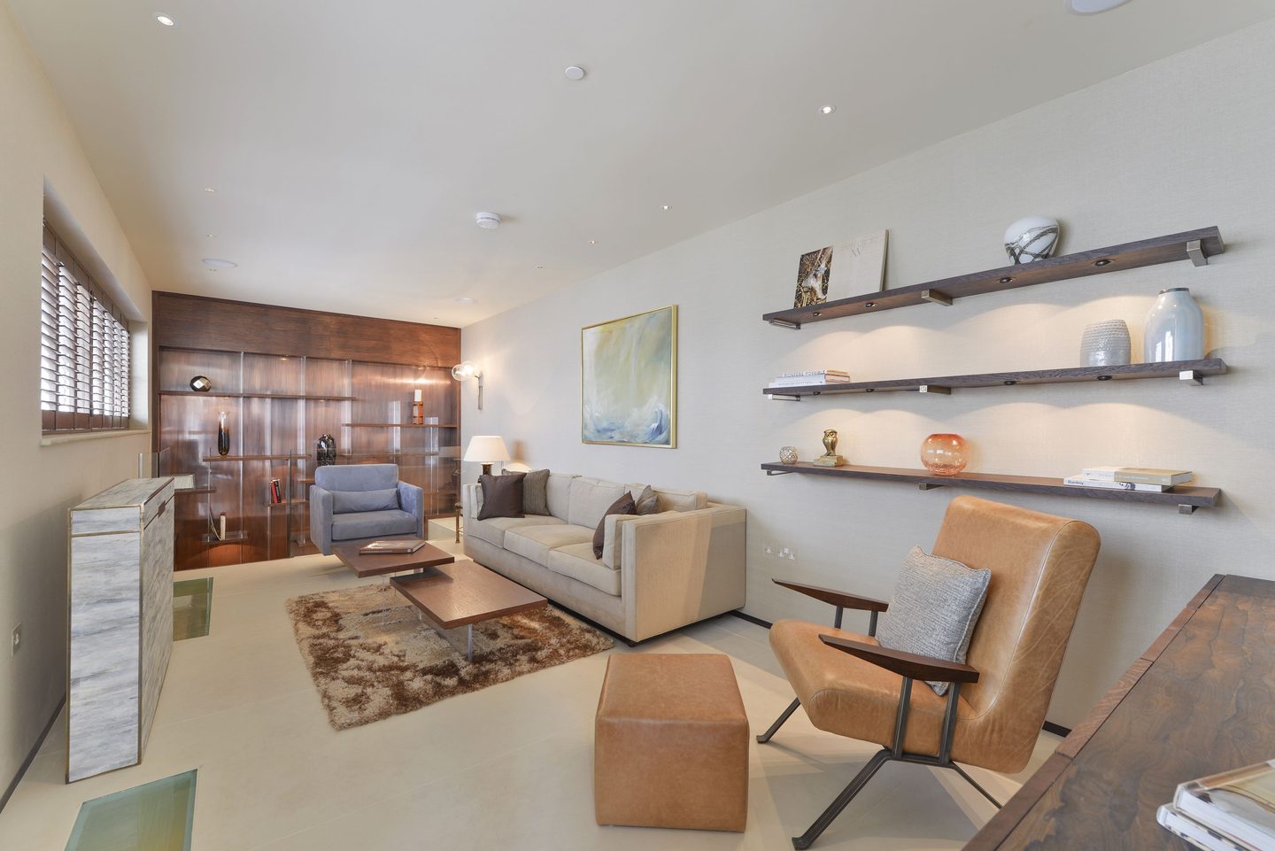 Living room with walnut panelling and floating shelves