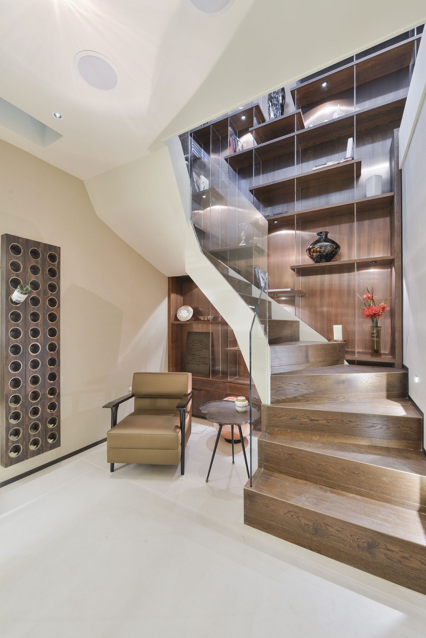 Staircase with glass balustrade and integrated wine storage