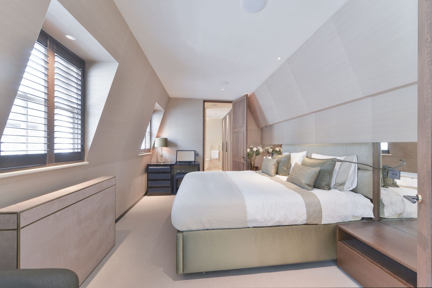 Loft bedroom beneath the mansard, with shuttered dormer