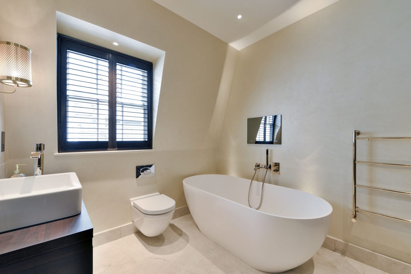 Bathroom with freestanding bath and shuttered window