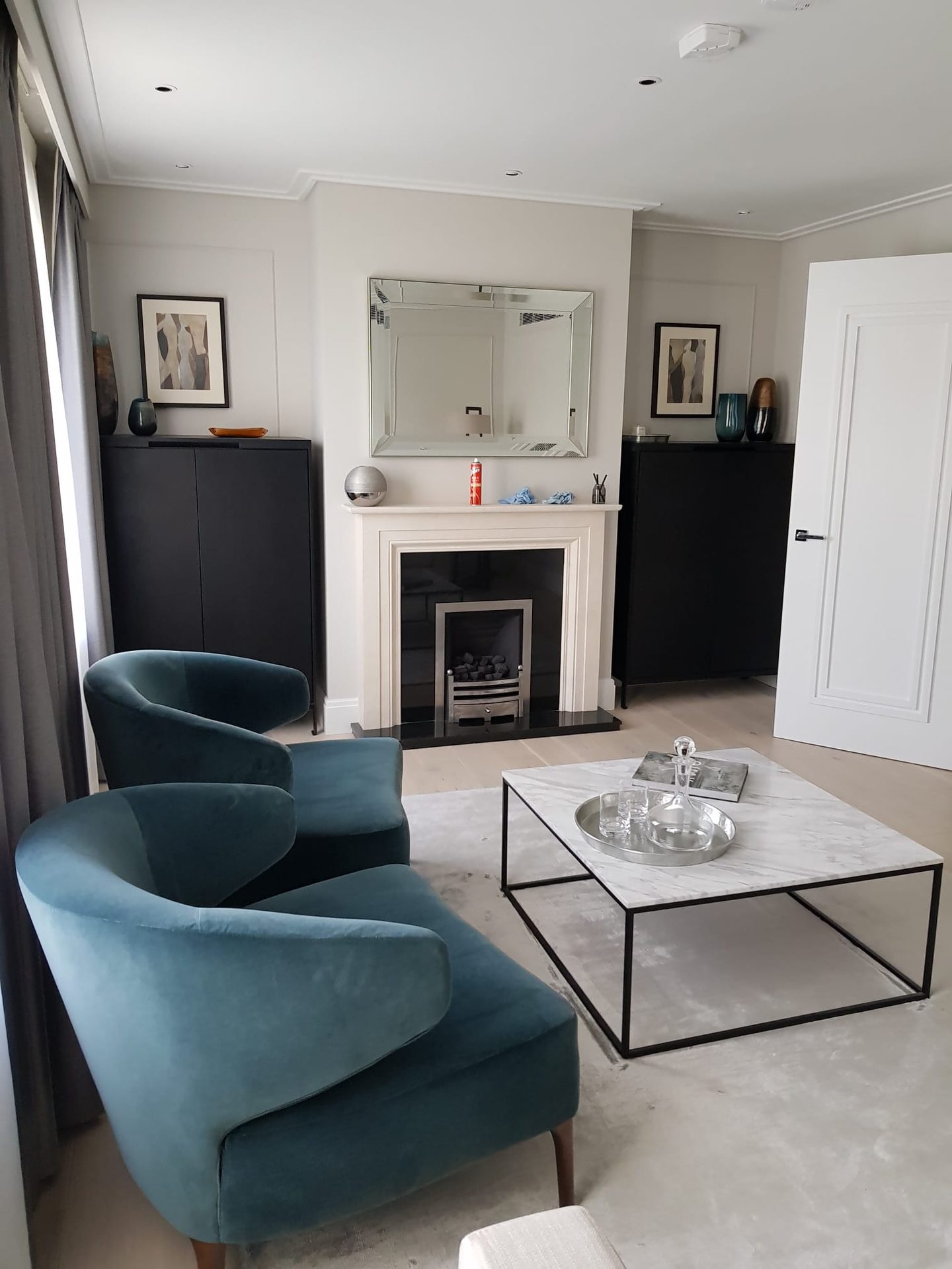 Sitting room with fireplace and armchairs